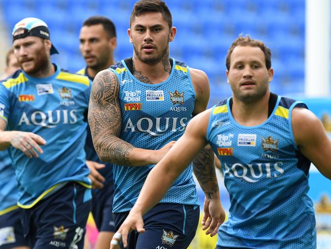 Daniel Vidot  (centre) during the Gold Coast Titans training session at Cbus Super Stadium in Robina on the Gold Coast, Wednesday, March 22, 2017. Vidot will  debut for the club when they play the North Queensland Cowboy's this weekend.  (AAP Image/Dave Hunt) NO ARCHIVING