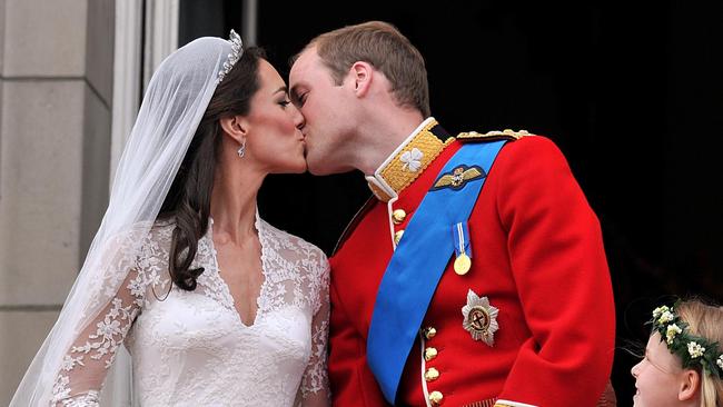 Prince William and his wife Kate, Duchess of Cambridge, kiss on the balcony of Buckingham Palace following their 2011 wedding at Westminster Abbey. Picture: AP