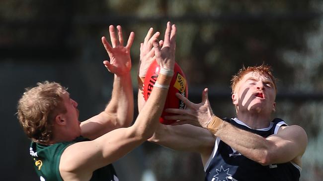 Hampden’s Paddy O’Sullivan and Ballarat’s Riley Miller go for the ball. Picture Yuri Kouzmin
