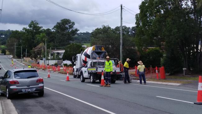 Logan City Council workers build kerbing on Fryar Road at Eagleby this week less than 100m from a property which was bought by the state government to make way for the Coomera Connector.