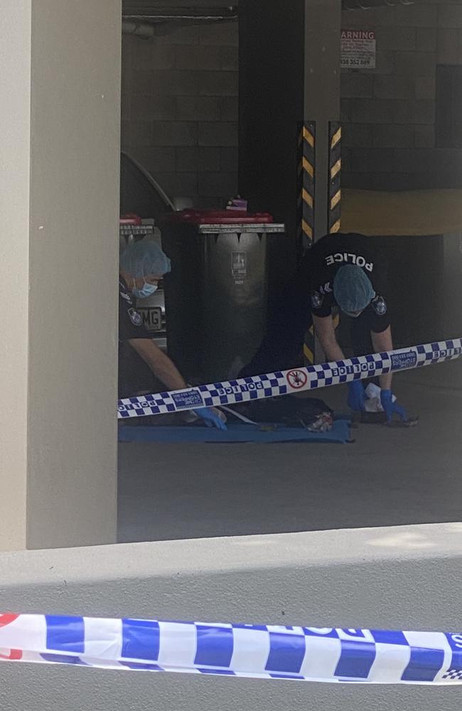 Forensic police look through a bag at the scene where a body was found. Picture: Samantha Scott