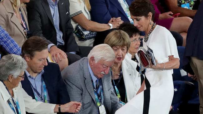 Always a party: Jayne Hrdlicka tries to get out of her seat, stepping past Margaret Court &amp; husband Barry at the Australian Open Women's Tennis final, at Rod Laver Area in Melbourne. Stuart McEvoy/The Australian.