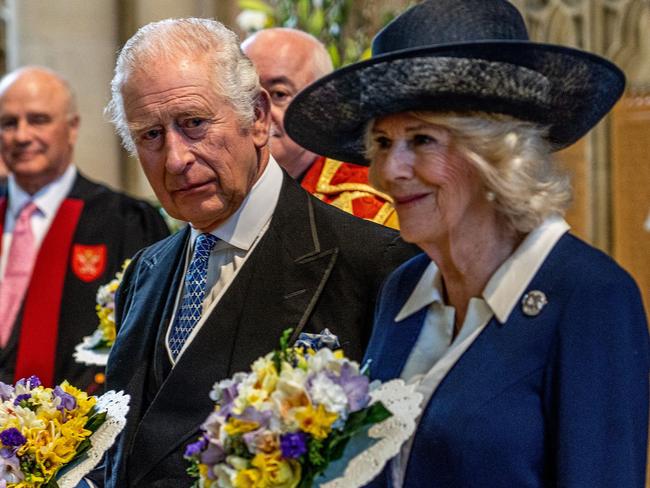 Britain's King Charles III (L) and Britain's Camilla, Queen Consort (R) stand with their traditional  nosegays as they attend the Royal Maudy Service where the King distributes the Maundy money to 74 men and 74 women, mirroring the age of the monarch, in York Minster, northern England on April 6, 2023, to thank them for their outstanding Christian service and for making a difference to the lives of people in their local communities. - Maundy Thursday is the Christian holy day falling on the Thursday before Easter. The King commemorates Maundy by offering 'alms' to senior citizens. Each recipient receives two purses, one red and one white. (Photo by Charlotte Graham / POOL / AFP)