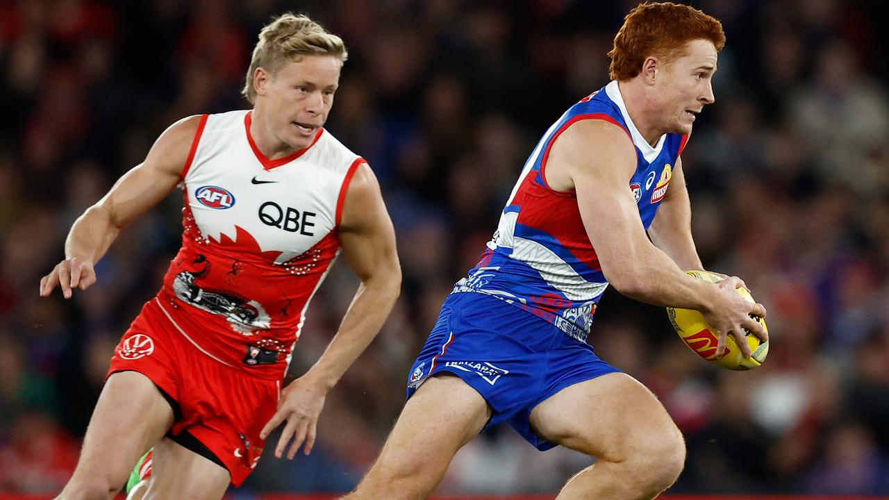 MELBOURNE, AUSTRALIA - MAY 23: Ed Richards of the Bulldogs is chased by Isaac Heeney of the Swans during the 2024 AFL Round 11 match between the Western Bulldogs and the Sydney Swans at Marvel Stadium on May 23, 2024 in Melbourne, Australia. (Photo by Michael Willson/AFL Photos via Getty Images)