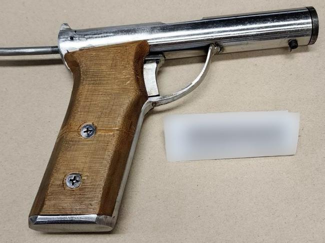 A man will appear in court today charged after shots were allegedly fired at a home in Newcastle last month. Items seized in a raid included firearms and a NSW Police cap. Picture: NSW Police/Supplied.