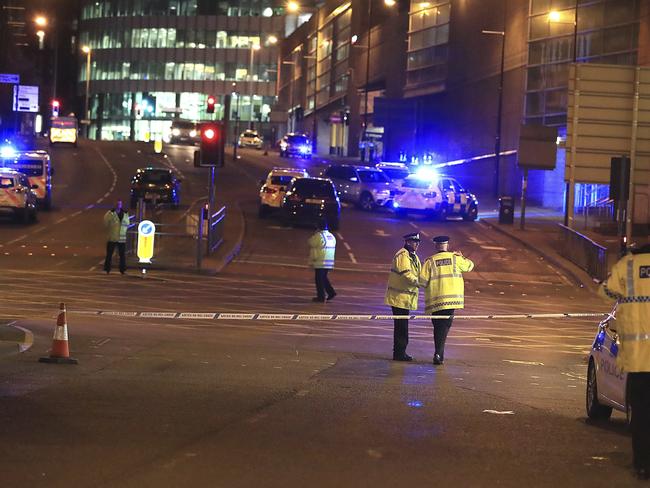 Emergency services work at Manchester Arena after reports of an explosion at the venue during an Ariana Grande gig in Manchester.