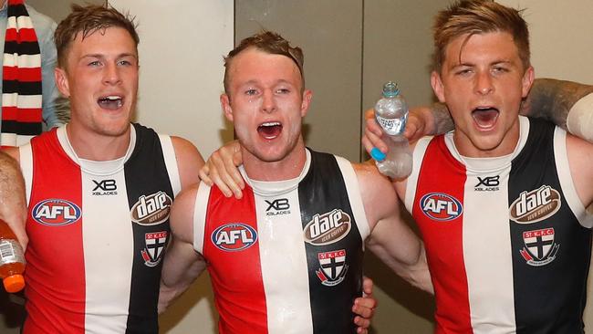 Jack Newnes, Nick Hind and Sebastian Ross belt out the Saints song after Saturday’s win. Picture: Michael Willson/AFL Photos via Getty Images.