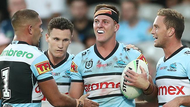 SYDNEY, AUSTRALIA - APRIL 03: Teig Wilton of the Sharks celebrates scoring a try with team mates during the round four NRL match between the Cronulla Sharks and the North Queensland Cowboys at Netstrata Jubilee Stadium, on April 03, 2021, in Sydney, Australia. (Photo by Mark Metcalfe/Getty Images)