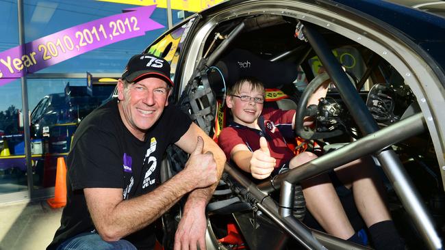 V8 Supercar driver Aaron McGill with young fan Kai Kennedy, 13, at Battery World in West Ipswich.