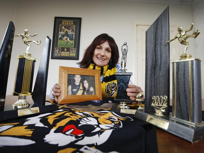 Dustin Martin’s mum Kathy with some of her son’s junior footy trophies. Picture: David Caird