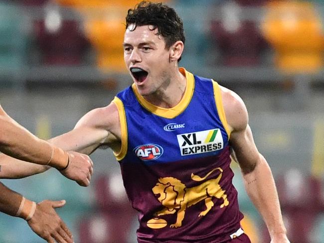 Lachie Neale (right) of the Lions celebrates kicking a goal with team mates during the Round 3 AFL match between the Brisbane Lions and the West Coast Eagles at The Gabba in Brisbane, Saturday, June 20, 2020. (AAP Image/Darren England) NO ARCHIVING, EDITORIAL USE ONLY