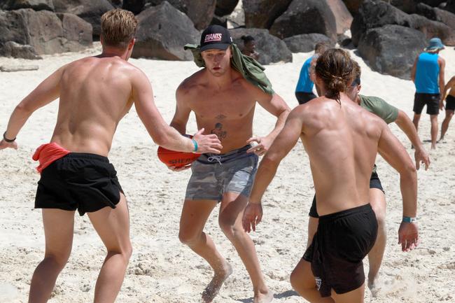 Jamison Shea (middle) looking to evade some potential defenders during the Southport Sharks VFL team preseason training camp at Tallebudgera beach. Picture: Mike Batterham.
