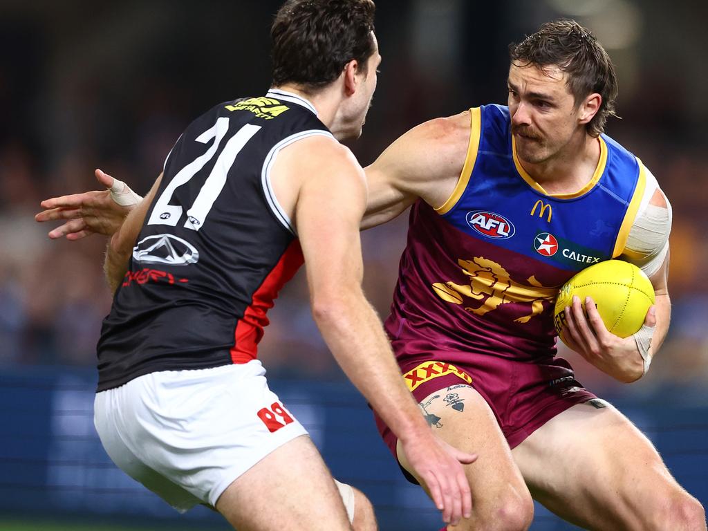 Joe Daniher tries to dance around Zaine Cordy. Picture: Chris Hyde/AFL Photos/via Getty Images