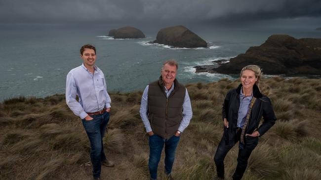 TRT Pastoral Group managing director Tim Roberts-Thomson with son James (left) and daughter Madeleine, overlooking the Doughboys and Bass Strait at Cape Grim. Picture: Phillip Biggs