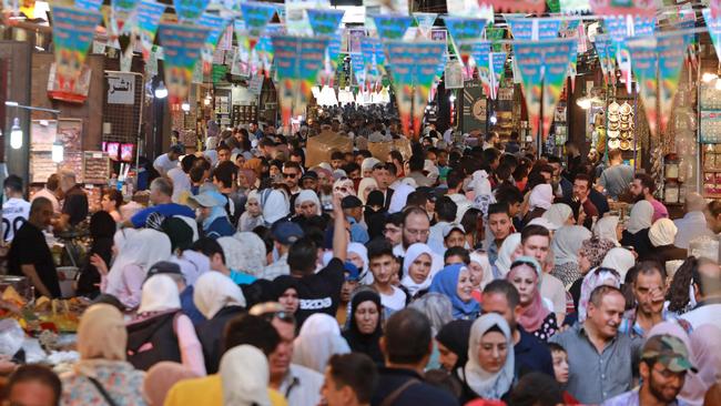 Syrians shop at a market in the capital Damascus this month. Picture: AFP