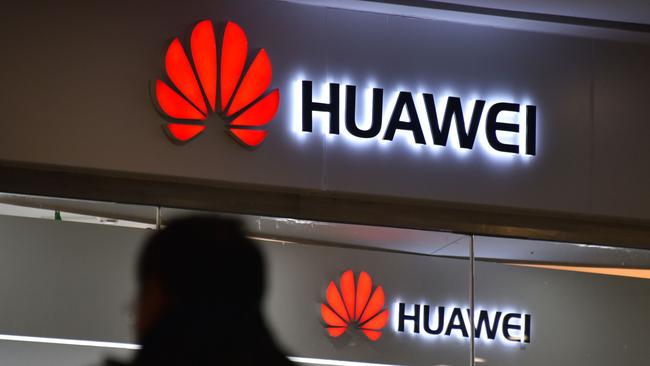 A man walks past a Huawei store in Beijing on December 10, 2018. - China on December 10 protested Canada's "inhumane" treatment of an executive of telecom giant Huawei who is being held on a US extradition bid, following reports she was not getting sufficient medical care. (Photo by GREG BAKER / AFP)