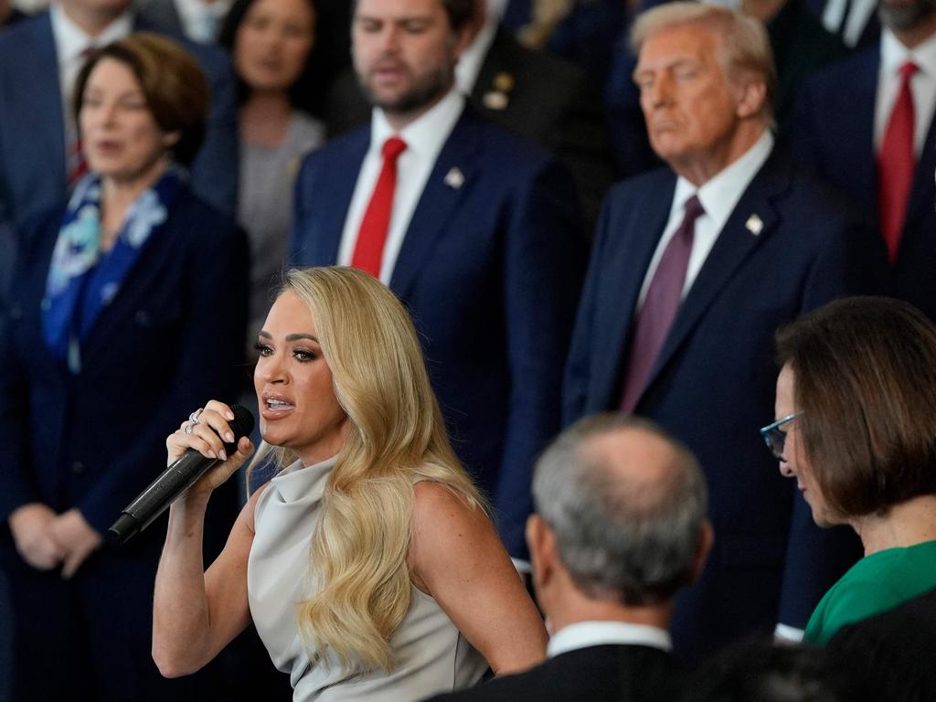 US President Donald Trump and Vice President JD Vance listen as Carrie Underwood performs America the Beautiful a capella style. Picture: AFP