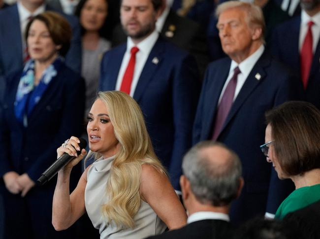 US President Donald Trump and Vice President JD Vance listen as Carrie Underwood performs America the Beautiful a capella style. Picture: AFP