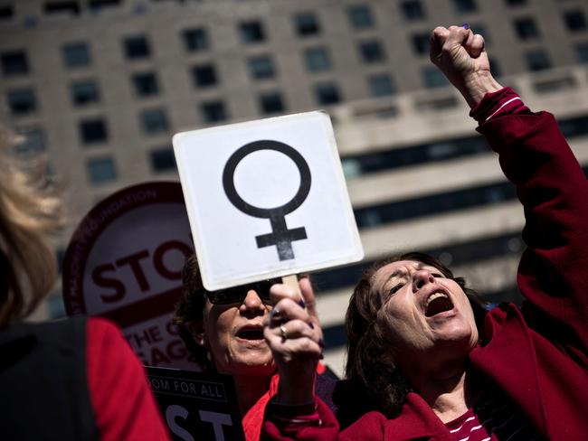 (FILES) In this file photo taken on March 08, 2017 Activists protest the Trump administration and rally for women's rights during a march to honor International Woman's Day in Washington, DC. - It's that time of year when radio stations across the United States are playing Christmas music nonstop. But one classic holiday song is proving too controversial for some stations in the wake of the #MeToo movement. "Baby, It's Cold Outside" -- a duet written in 1944 and performed over the years by scores of artists, including Dean Martin, Dolly Parton, Ray Charles and Lady Gaga -- has turned into a hot potato for broadcasters, some of which have yanked the popular song on grounds the lyrics are predatory toward women. (Photo by Brendan Smialowski / AFP)