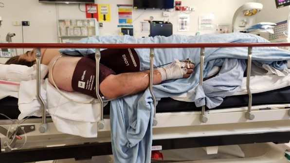 Ethan Desborough in hospital after he was seriously injured with heavy steel beams fell on his back in a workplace incident at Paget. Picture: Supplied by Desborough family