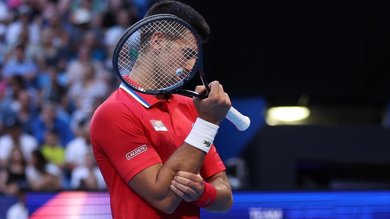 Novak Djokovic of Team Serbia holds his right forearm during his singles match against Alex de Minaur of Team Australia during day six of the 2024 United Cup at RAC Arena on January 03, 2024 in Perth, Australia. (Photo by Paul Kane/Getty Images)