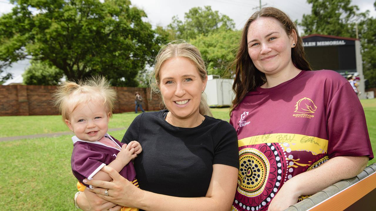 Dannielle George holding Remie George and, Steph Wise wait to meet the players at the Brisbane Broncos Captain's Run and Toowoomba Fan Day at Toowoomba Sports Ground, Saturday, February 15, 2025. Picture: Kevin Farmer