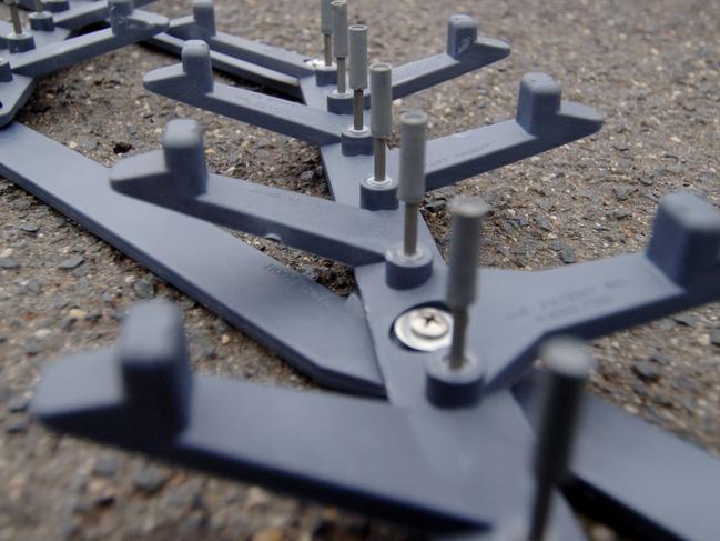 The Highway Patrol officer was struck as he was deploying road spikes similar to these (file image).