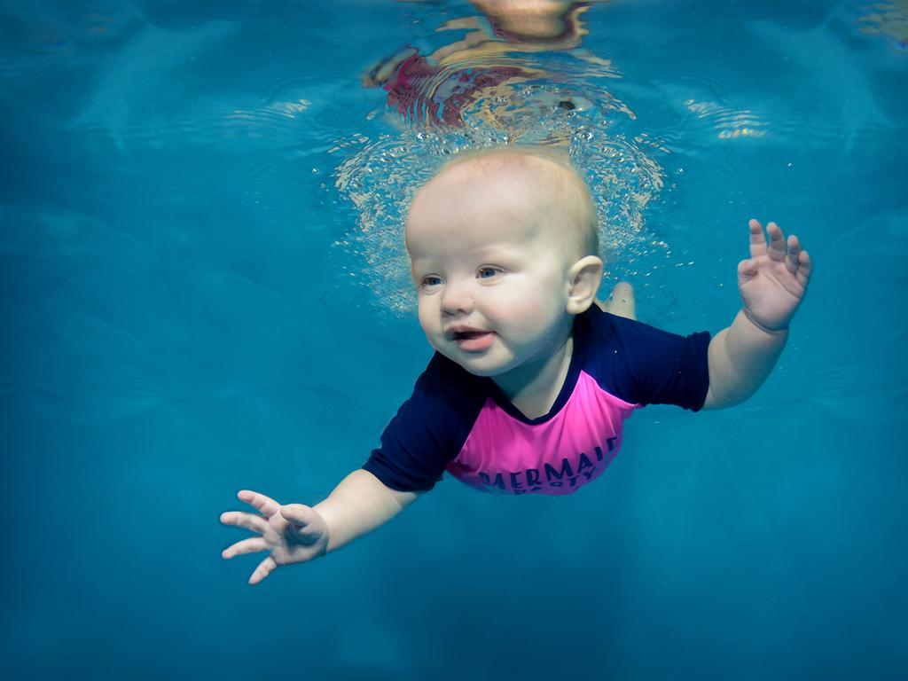 Kids smile for the underwater camera | Daily Telegraph