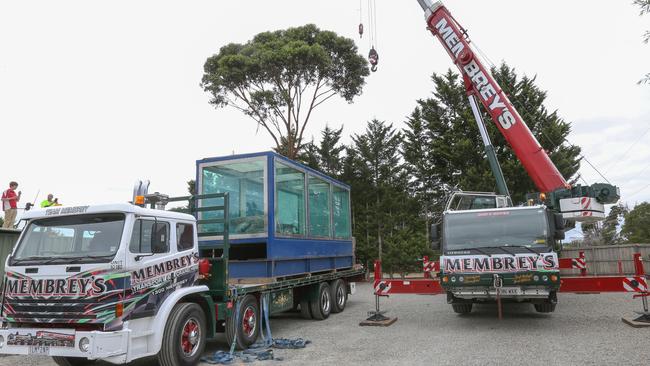 A crane prepares to move the massive shark and its tank. Picture: Ian Currie