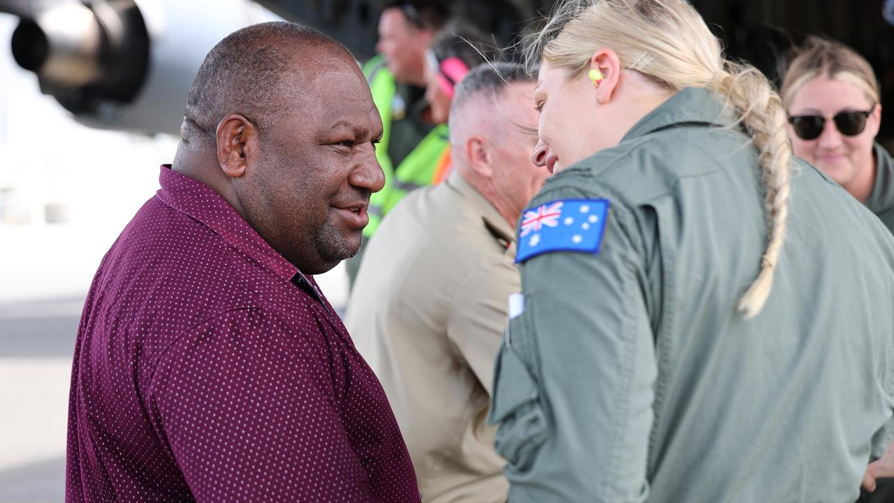 Papua New Guinea Defence Minister, the Hon Win Bakri Daki MP, talks to a Royal Australian Air Force aviator at an event to commemorate the 80th anniversary of the 1943 Nadzab Landings.