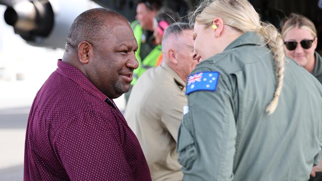 Papua New Guinea Defence Minister, the Hon Win Bakri Daki MP, talks to a Royal Australian Air Force aviator at an event to commemorate the 80th anniversary of the 1943 Nadzab Landings.