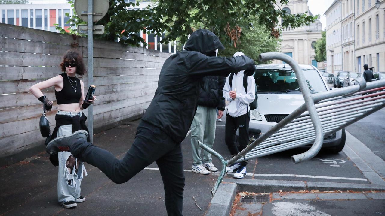 A protester throws a metal barrier during a demonstration in Caen. (Photo by LOU BENOIST / AFP)