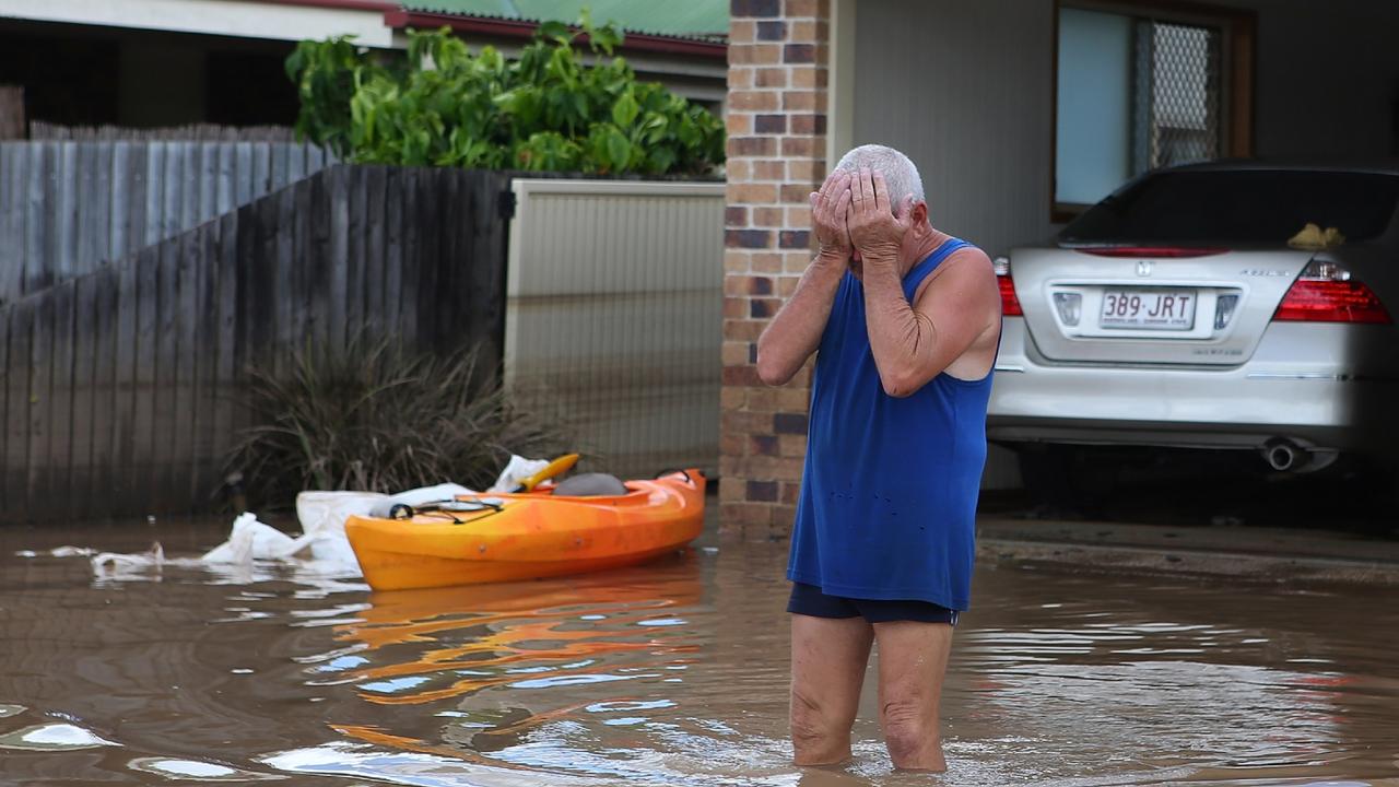 A resident reacts to the damage to his house as parts of southern Queensland experiences record flooding in the wake of Tropical Cyclone Oswald on January 30, 2013 in Bundaberg. Picture: Chris Hyde/Getty Images