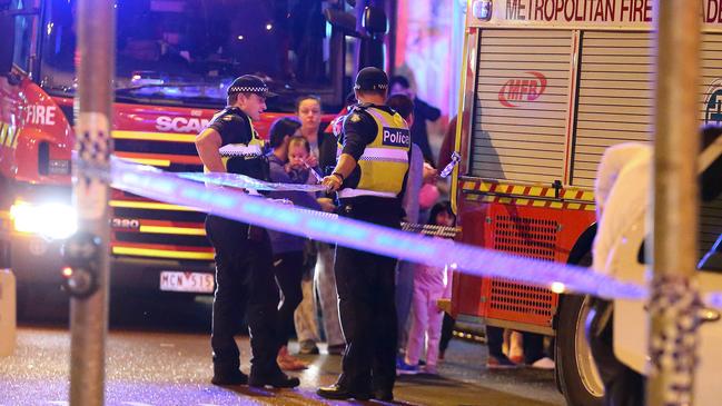 Children in pyjamas stand near police after apartments flooded. Photo: Patrick Herve