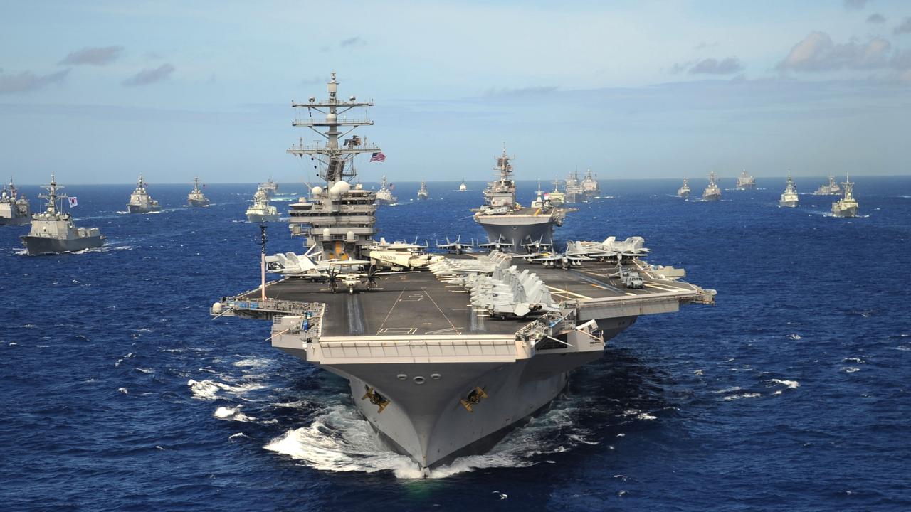 D4NHD2 US Navy Nimitz-class nuclear aircraft carrier USS Ronald Reagan leads a group of multinational ships in the Pacific Ocean.