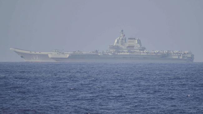 Chinese aircraft carrier <i>Shandong </i>pictured in Pacific Ocean waters on Friday. A Chinese anti-submarine helicopter and three warships were detected around the Taiwan. Picture: AFP