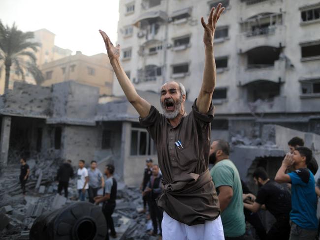 A Palestinian shouts following an Israeli strike, in Khan Yunis in the southern Gaza Strip on October 14, 2023. Picture: Yasser Qudih / AFP.