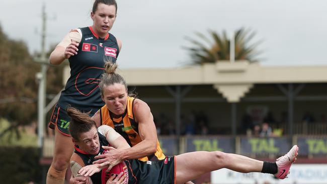 MELBOURNE, AUSTRALIA - OCTOBER 19: Alicia Eva of the Giants is tackled by Emily Bates of the Hawks during the round eight AFLW match between Hawthorn Hawks and Greater Western Sydney Giants at Kinetic Stadium, on October 19, 2024, in Melbourne, Australia. (Photo by Daniel Pockett/Getty Images)