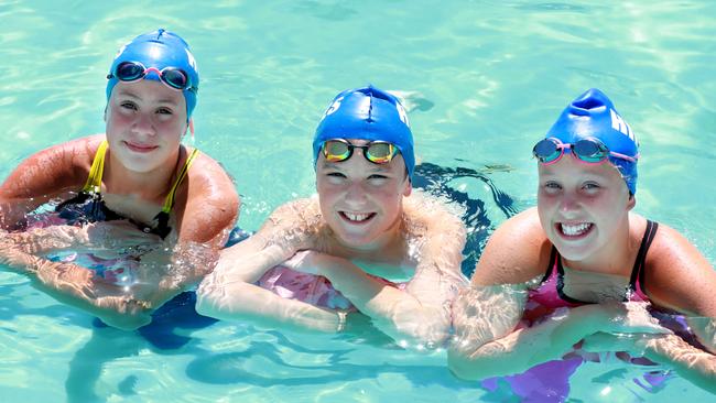 Hills Swimming Club swimmers Alanah Mabilia, 12, Alexander Clarence, 12, and Phoebe Reynolds, 11, pose for photographs in Baulkham Hills. Picture: Angelo Velardo