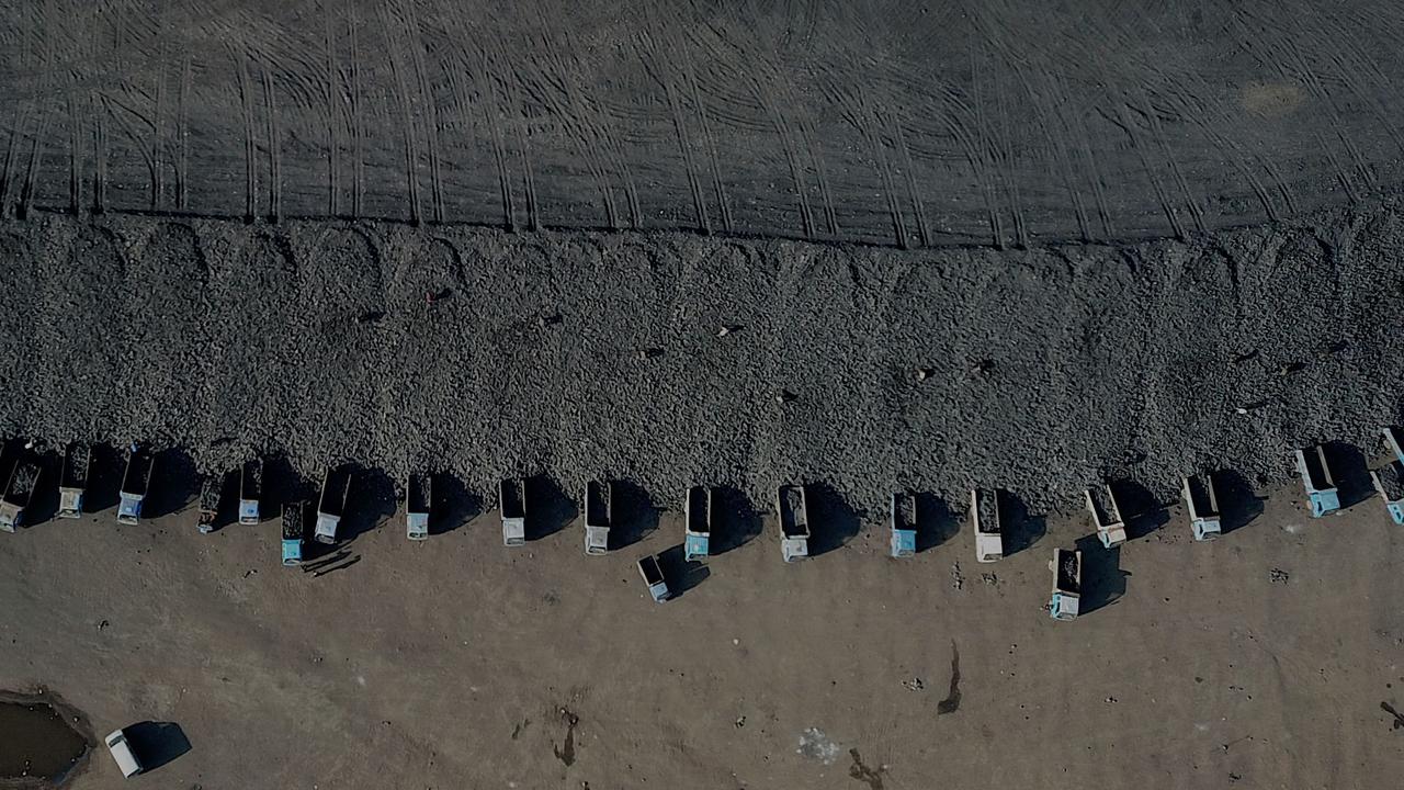 This aerial view shows coal being loaded onto trucks near a coal mine in Datong, China. China is also missing from the coal pledge. Picture: Noel Celis / AFP