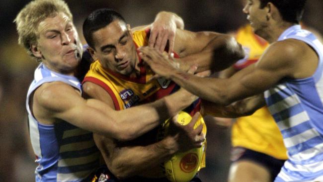 Kane Cornes tackles Andrew McLeod in the 2005 Heritage Round Showdown.