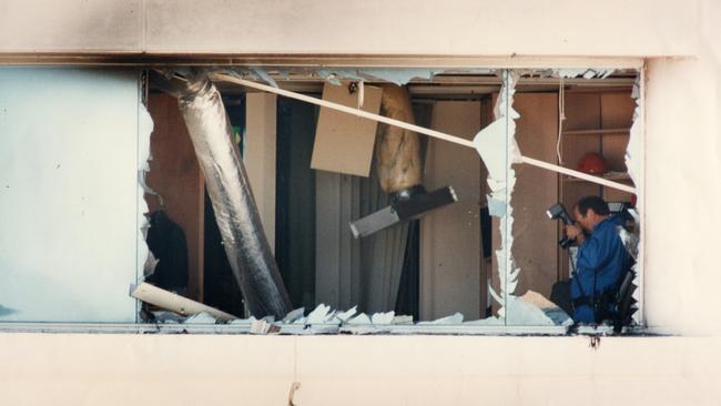 Bomb explosion at the National Crime Authority (NCA) office on the 12th floor of the CPS Credit Union building in Waymouth Street, Adelaide, 02 Mar 1994. Police forensic staff sift through the damage to the bombed out office.