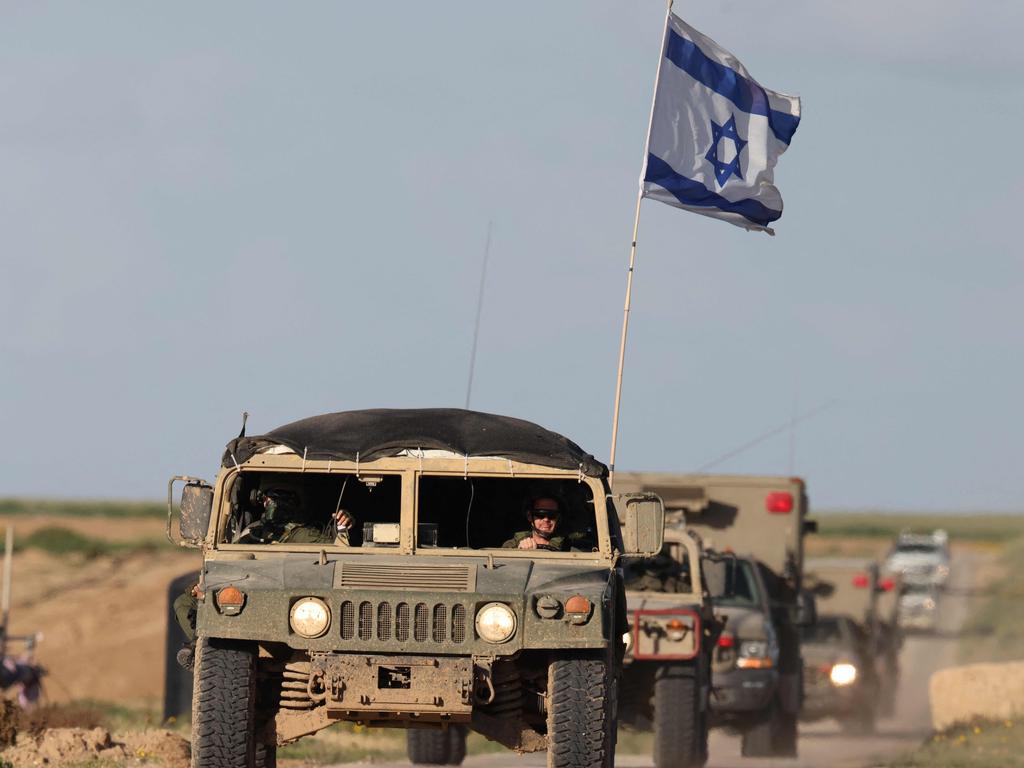 Israeli armoured personnel carriers leaving Gaza amid continuing battles. Picture: AFP