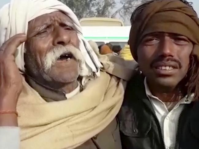 In this image from video, a man grieves at the site where a truck loaded with sand collided with a school bus in the northern Indian state of Uttar Pradesh Thursday, Jan. 19, 2017. The collision early Thursday killed over 20 children. (KK Production via AP)