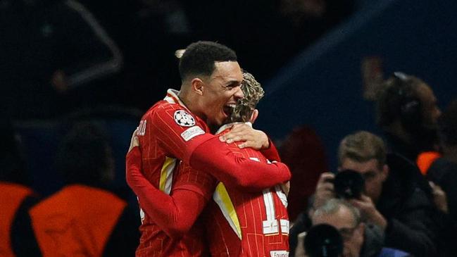 Liverpool's English forward #19 Harvey Elliott (CR) celebrates with Liverpool's English defender #66 Trent Alexander-Arnold (CL) after scoring Liverpool's first goal during the UEFA Champions League Round of 16 first leg football match between Paris Saint-Germain (FRA) and Liverpool (ENG) at the Parc des Princes stadium in Paris on March 5, 2025. (Photo by GEOFFROY VAN DER HASSELT / AFP)