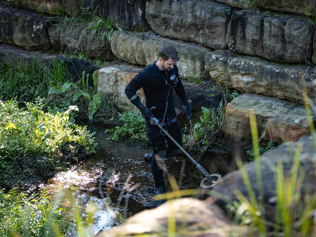 Officers searched the area of the murder weapon. Picture: Julian Andrews