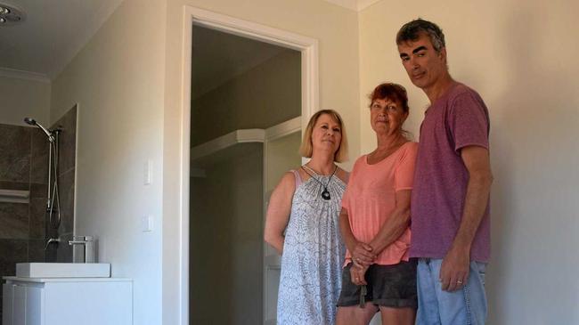 Lynette Arnall, Janine Lockhart and Tom DeFlorencas in the duplex which was left incomplete when Stirling Homes went bust. Picture: Scott Kovacevic