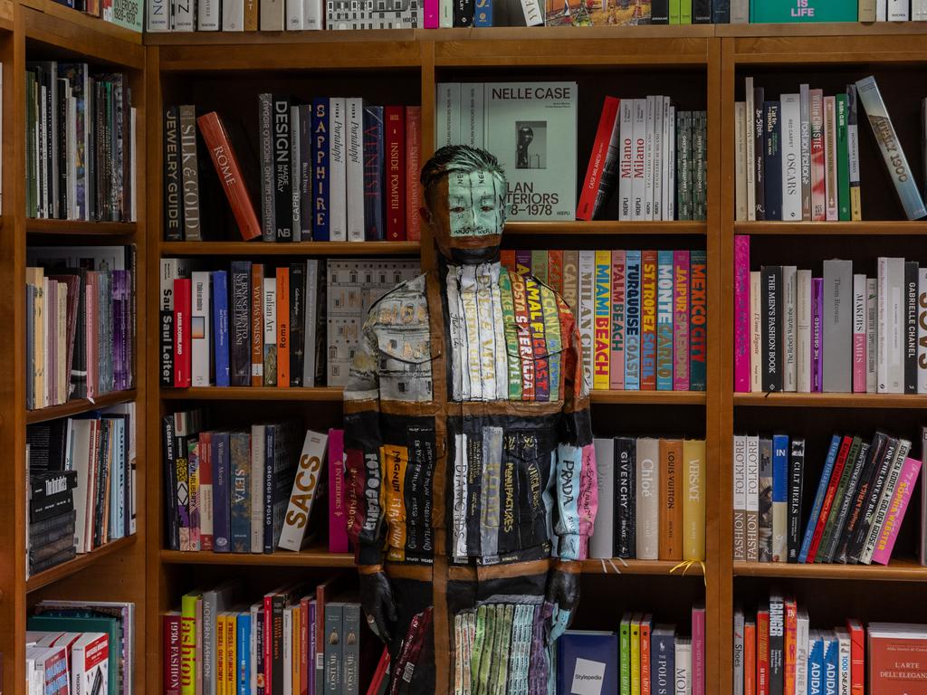 Chinese artist Liu Bolin, known as “the invisible man,” performs his camouflage art at Libreria Hoepli in Milan. Picture: Emanuele Cremaschi/Getty Images