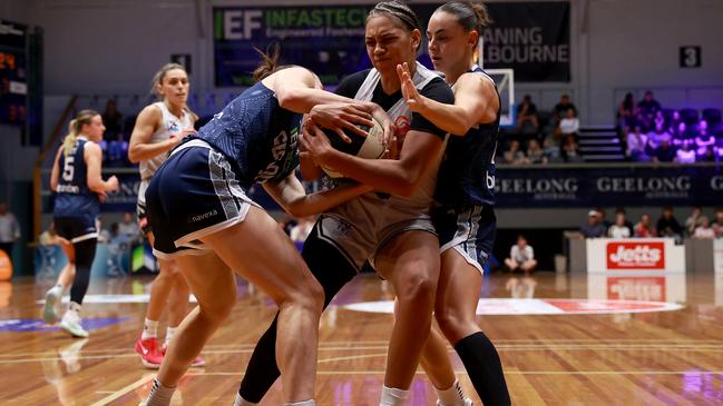 GEELONG, AUSTRALIA - DECEMBER 14: Shaneice Swain of the Flames competes for the ball  against Gemma Potter of Geelong United and Monique Conti of Geelong United during the round seven WNBL match between Geelong United and Sydney Flames at The Geelong Arena, on December 14, 2024, in Geelong, Australia. (Photo by Kelly Defina/Getty Images)