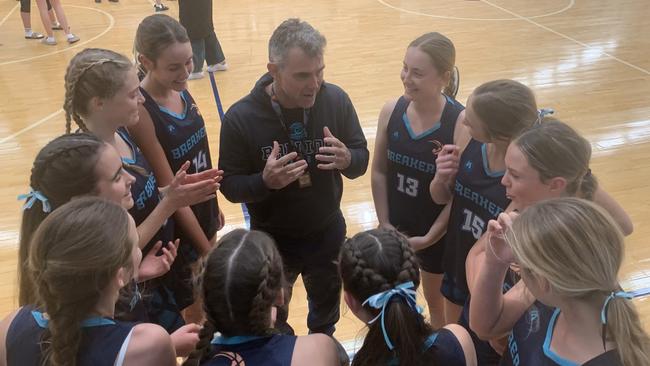 The Ballina Breakers team huddles with coach Martin Smith.